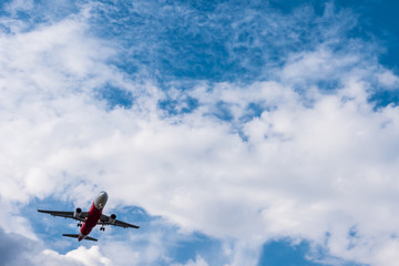 Fototapeta na wymiar Airplane flying on blue sky. Free space for text
