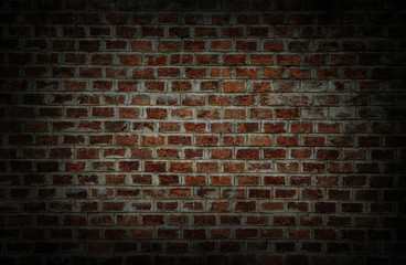 Fototapeta na wymiar Background and Wallpaper or texture which has dim light of dark discolored old brick wall ancient vintage retro style have damage and cracks.