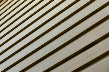 Part of the wall of the village house with the doppler effect. Diagonal light and dark stripes. Density of the stripes varies as with the effect of the doppler