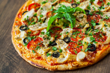Pizza with Chicken meat, Mozzarella cheese, tomato, olive. Italian pizza on wooden background