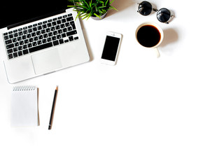 Work place in flat lay style. Modern white office desk table with laptop, smartphone, office plant,...