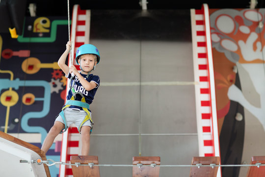 Young Child Crossing A Bridge At The High Rope Course