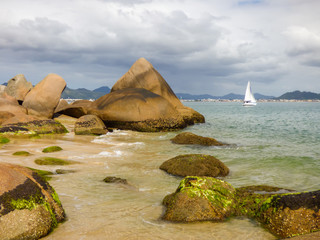 Rocky shore of Ponta das Canas beach in Florianopolis, Brazil © Helissa
