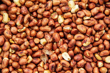 Background and texture of Pile of fresh peanuts roasted dry fried in a saucepan.