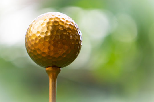 Golf golf ball and pins gold against the background of natural beauty, the ultimate victory of golf