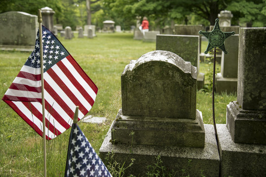 Small American flags and headstones in Boston MA
