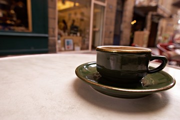 Coffee cup on the table in coffee shop people background