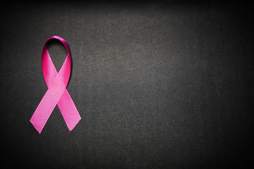 Pink ribbon for breast cancer awareness, symbolic bow color raising awareness on people living with women's breast tumor illness. bow isolated with clipping black background