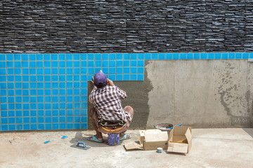 Construction Pool.Tiled pool. Installation of floor and wall tiles.