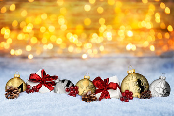 Cryptocurrency xmas background crypto coin christmas bauble balls and gifts in snow in front of warm lights bokeh snow texture