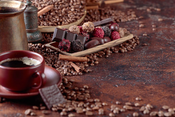 Various chocolates  and cup of black coffee.