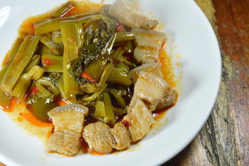 spicy fried morning glory with fat pork curry on plate
