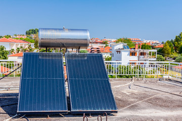 Solar panel, water heater on house roof, green energy