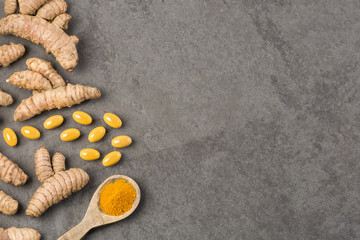Roots, powder and turmeric pills - Curcuma longa. Top view