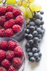 a hand with a beautiful manicure holds a cake in a Cup with berries and chocolate