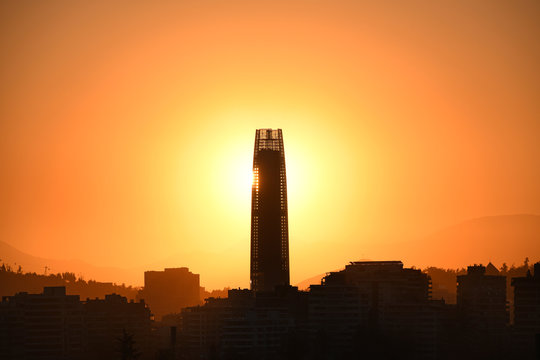 Sun setting behind a skyscraper in Santiago de Chile