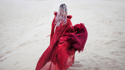 Woman in red. Run away girl in amazing scarlet dress. back view