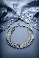 Faux diamond necklace and lace trimmed lingerie.