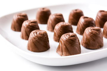 pieces of bonbons on white plate isolated on white background
