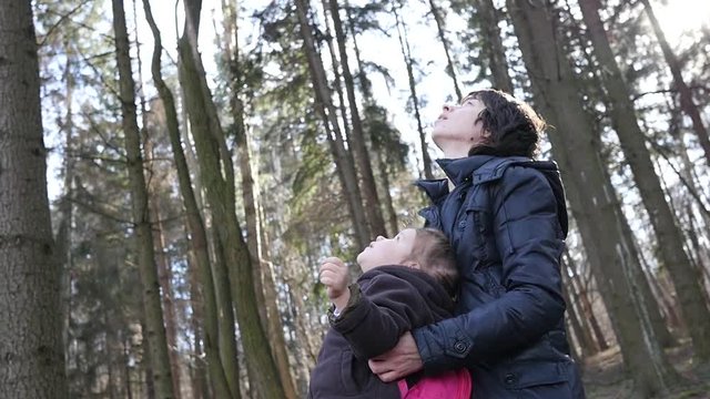 Mom tells little daughter about God and they look at the sky