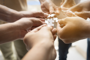 Hand teamwork together pick puzzle piece  business jigsaw,agree to coporation success in business.
