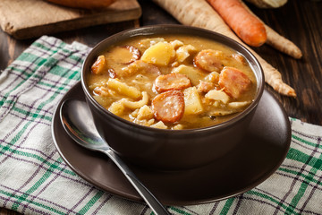 Traditional Polish split pea soup with sausage, bacon and potatoes