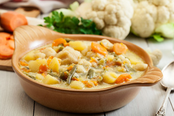 Vegetable soup with ingredients carrot, cauliflower, potato and
