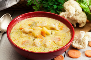 Vegetable soup with ingredients carrot, cauliflower, potato and parsley