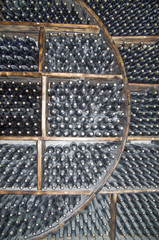 Wine cellar with bottles of aging wine