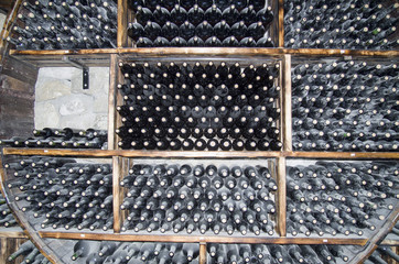 Wine cellar with bottles of aging wine