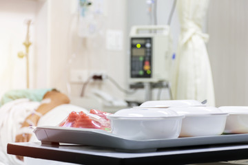 The food was placed on the table, And background is the patient is sleeping.