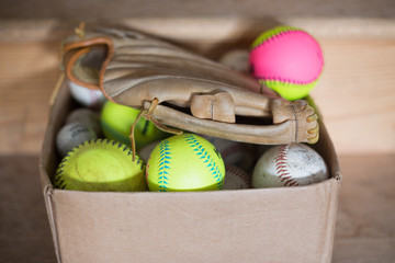 Baseballs and baseball glove.