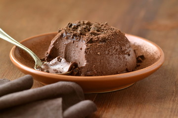 Cocoa panna cotta decorated with black grated chocolate, delicious dessert