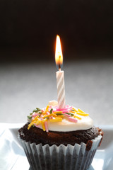 Birthday Cup Cake With One Light Candle