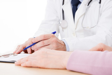 Doctor and patient are discussing something, just hands at the table, medical insurance.