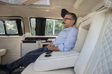Businessman in Moving Car