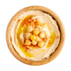 Classic chickpea hummus with olive oil and paprika in wooden bowl isolated on white.