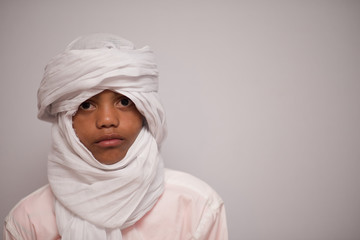 African boy with white headscarf on