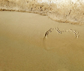 Heart drawn on the mediteranean sandy beach