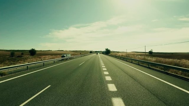 POV driving shot of a highway in central Spain on a sunny summer day