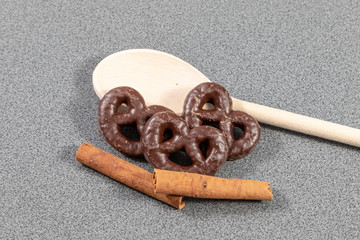 Stilllife of gingerbread pretzels beside wooden spoon and cinnamon sticks