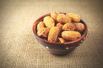 Indian dry dates in a wooden bowl