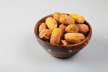Indian dry dates in a wooden bowl