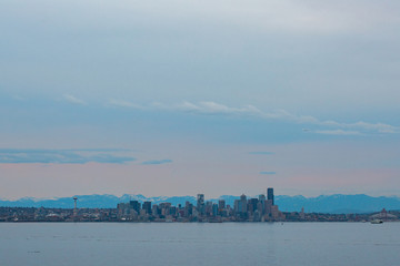 Seattle cityscape over water at sunset