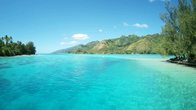 Traveling past tropical coast in Tahiti, slow motion