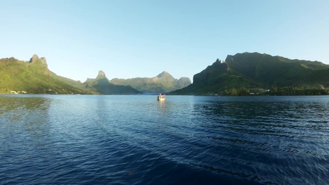 Slow motion aerial, boat off Tahiti coast