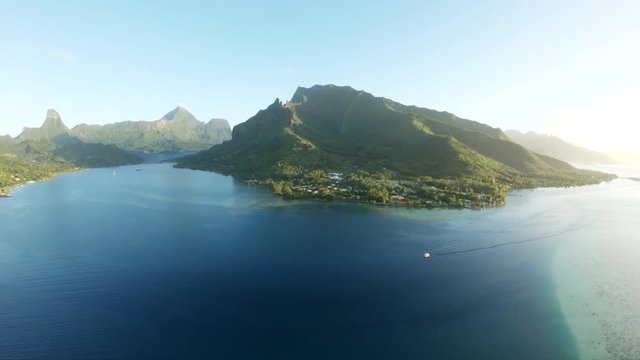 Sun shines over Tahiti coast, wide aerial