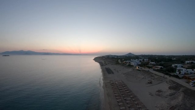 Wide aerial, sunset over beach in Greece