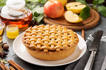 Popular American apple pie piece and cup of tea on gray table background. 