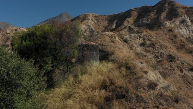Flight down a creek under an abandoned bridge in the middle of the forest.